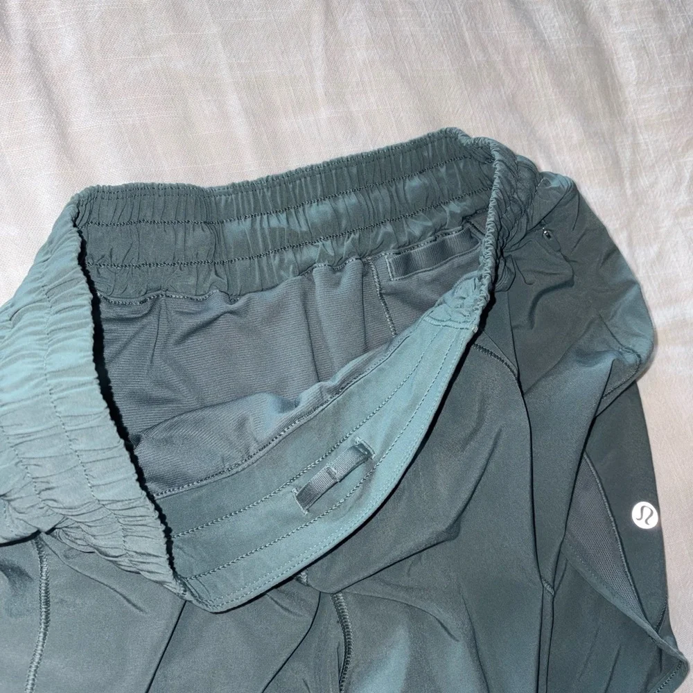 lululemon athletica dark green athletic shorts with reflective accents